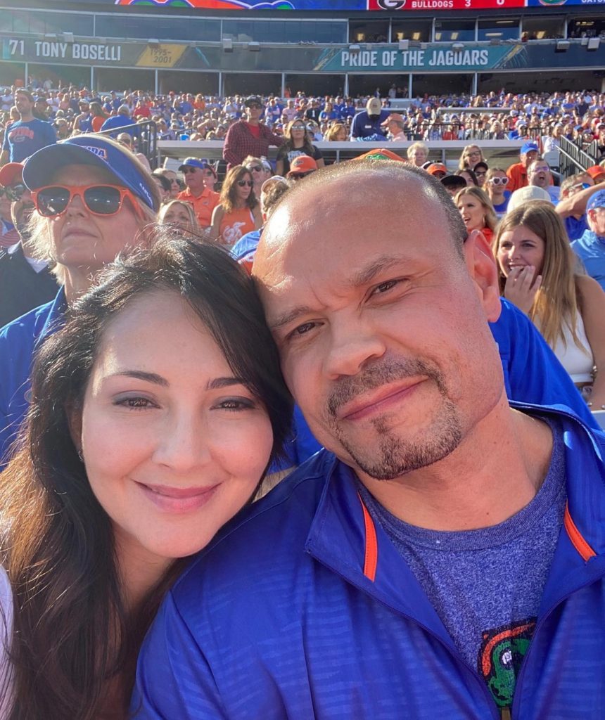 Paula Andrea Bongino watching football together with her husband in 2021